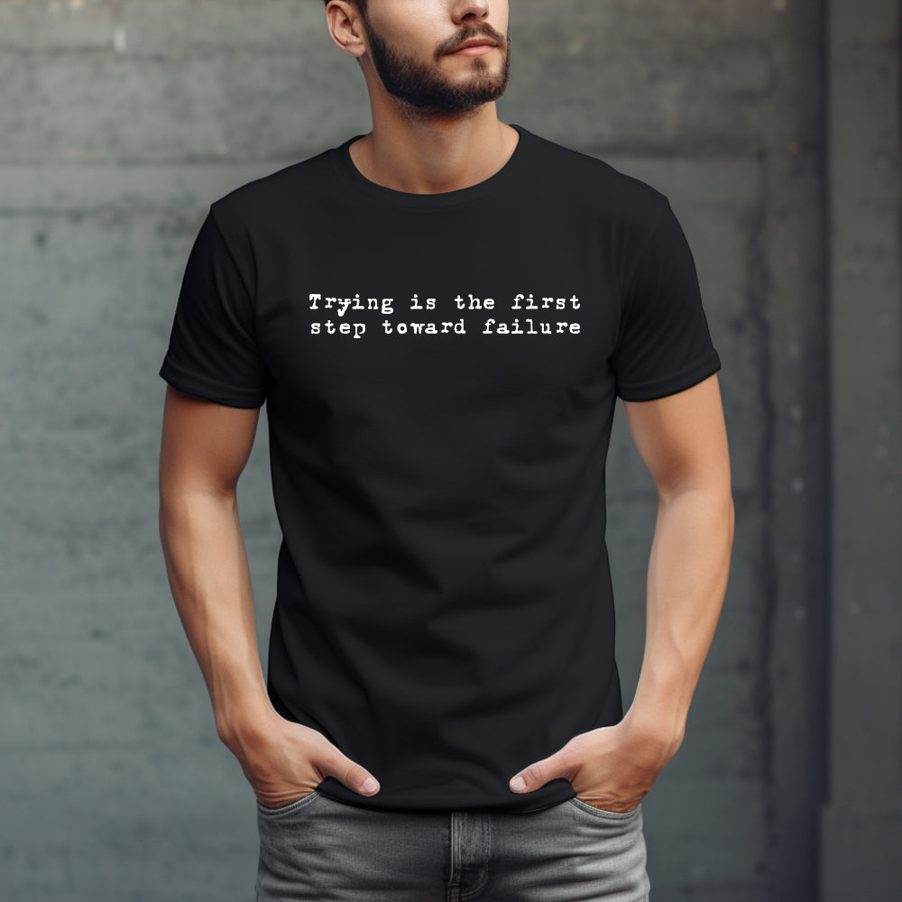 Black t-shirt with "Trying is the first step toward failure" in small white text on the chest in an old typewriter font